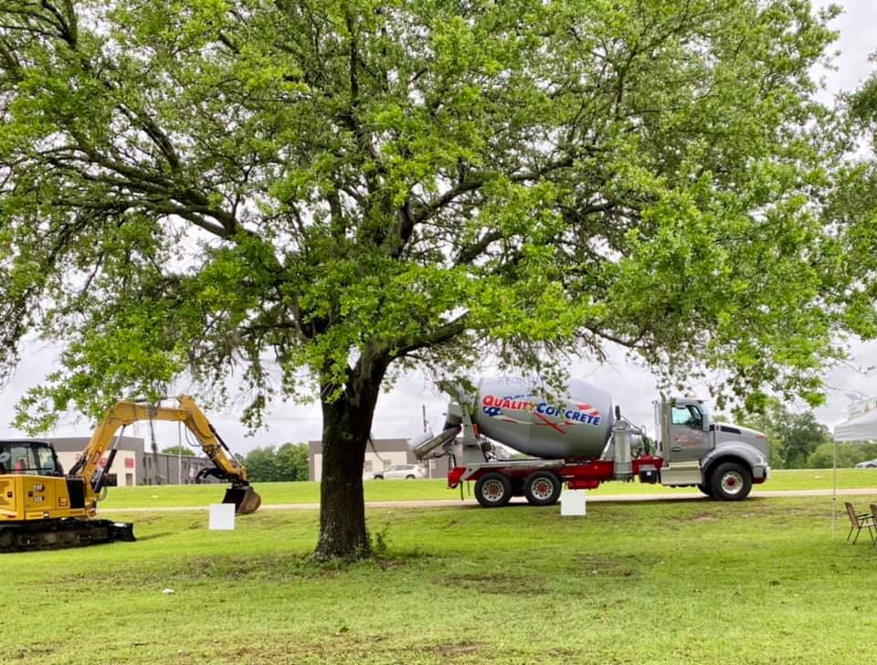 concrete truck and a machine on a field